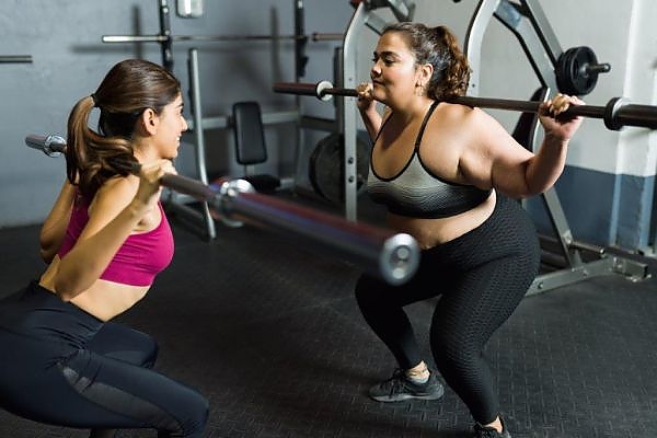 2 Young Girls Barbell Squats