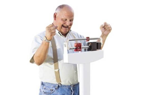 Man Excited Losing Weighton Scale