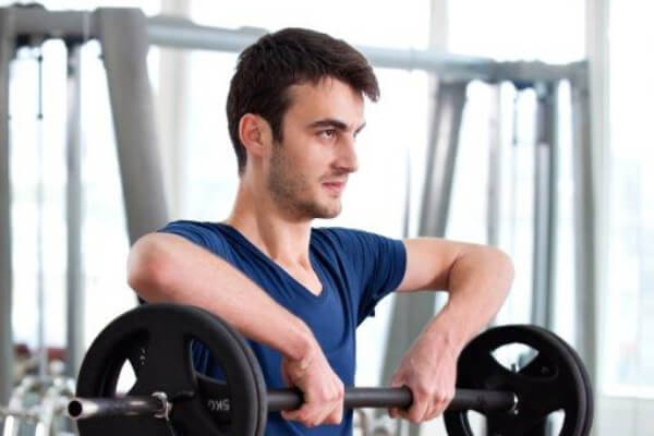 Young Man Barbell Shoulder Uprights